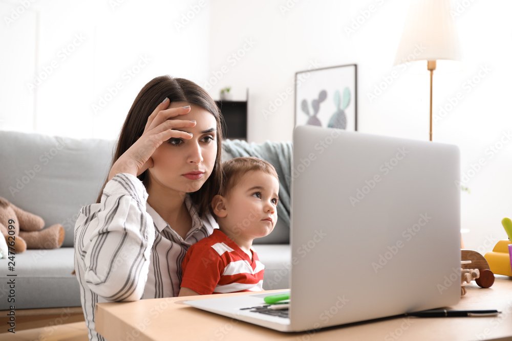 Young mother with her son working at home