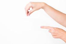 Closeup View Of Female Hands Holding Nothing Isolated On White Background. WOman Pointing At Something With Index Finger. Put Anything You Need In Empty Place. Horizontal Color Photography.