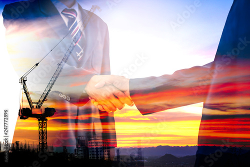 Cuadros en Lienzo Two male executives have joined hands because of the two business cooperation agreements that have achieved success in the investment of the construction business