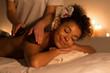 © Prostock-studio - African-american woman getting stones arm massage in spa