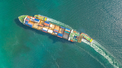 Container ship in export and import business logistics and transportation. Cargo and container box shipping to harbor by crane. Water transport International. Aerial view and top view.