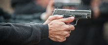 Left Hand Shooter Shooting And Holding Gun. Close-up Detail View
