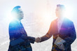 © khwanchai - shake hands and negotiation  with city, success and connection concept
