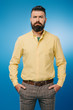 © LIGHTFIELD STUDIOS - serious bearded man looking at camera isolated on blue