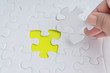 © instagram.com/_alfil - Hand put the last piece of jigsaw puzzle closeup to complete the mission. Selective focus and crop fragment