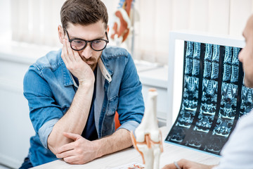 Man with sad emotions during the medical consultation at the therapist office