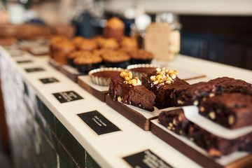 Assortment of delicious desserts in a bakery's glass display case