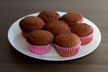 Wall Mural - chocolate muffins on wooden table