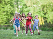 © Andrey - A group of happy children of boys and girls run in the Park on the grass on a Sunny summer day . The concept of ethnic friendship, peace, kindness, childhood.