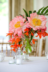 Wall Mural - Pink and red bouquet of flowers on a table during a wedding event 