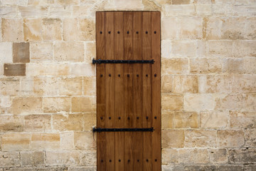 Wall Mural - Wooden door in old stone wall