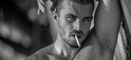 Portrait of a handsome caucasian male model posing on the beach