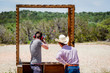 Shooting clay pigeons in Texas USA, watched by a real cowboy
