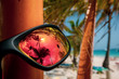 Orange sunglasses with palm trees at the beach of Punta Cana in the Dominican Republic