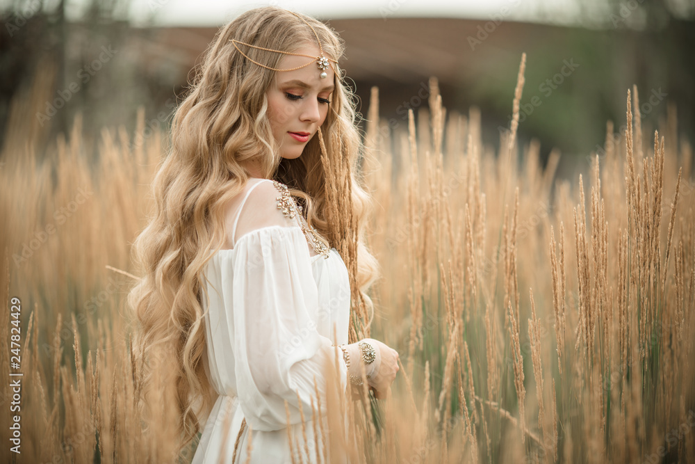 Happy smiling blonde girl is wearing white fashion dress with long blonde  hair in field of ray Stock Photo | Adobe Stock