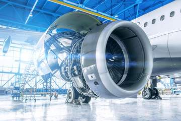 industrial theme view. repair and maintenance of aircraft engine on the wing of the aircraft.