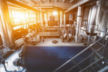 interior boiler room with gas boilers and pipes for supplying gas and steam. Top view with sunlight from the window