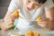 © pairhandmade - Boy ready to eat sticky stretch fried cheese ball - people and delicious cheese food concept