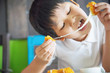 © pairhandmade - Boy ready to eat sticky stretch fried cheese ball - people and delicious cheese food concept