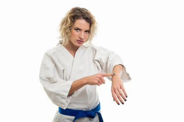 Wall Mural - Portrait of female wearing martial arts uniform showing wrist watch