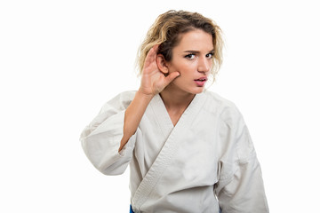 Wall Mural - Portrait of female wearing martial arts uniform making can't hear gesture