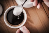 Fototapeta  - Adding Sugar to Coffee