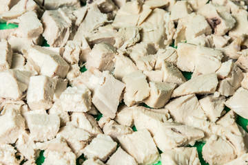 Wall Mural - Diced boiled chicken meat on a green board