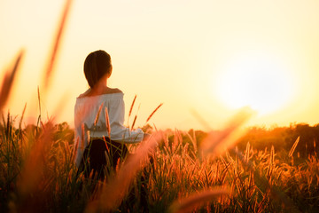 Wall Mural - Beautiful Young Woman in a field.