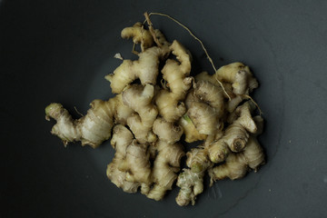 Wall Mural - Ginger on black plate for food content.