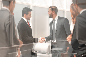 handshake business partners in a modern office