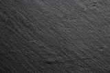 Fototapeta Desenie - Extreme close up of the texture of a dark stone kitchen board