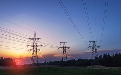 Wall Mural - high-voltage power lines at sunset. electricity distribution station