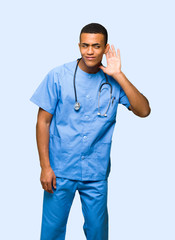 Wall Mural - Surgeon doctor man listening to something by putting hand on the ear on isolated background