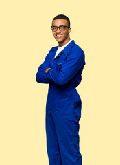 Wall Mural - Young afro american worker man with glasses and happy on isolated background