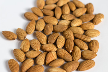 handful of almonds on white background