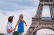 © travnikovstudio - Happy dad and little adorable girl traveling in Paris near Eiffel Tower