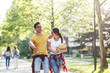 © BalanceFormCreative - Young student couple going to college class. They walk through university campus and having fun.