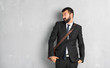 © luismolinero - Businessman with beard is a little bit nervous and scared pressing the teeth