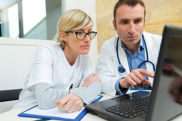 doctors working with laptop computer