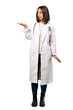 © luismolinero - A full-length shot of a Young doctor woman holding copyspace imaginary on the palm to insert an ad over isolated white background