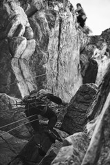 Wall Mural - Two climbers climbs up the complex rocky terrain. Sport climbing. Black and white.