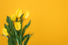 Top View Of Bouquet With Yellow Tulips On Orange Background