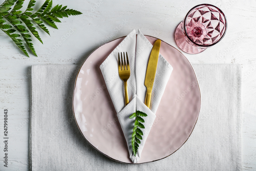 Simple table setting on white wooden background