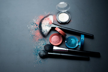 Wall Mural - Cosmetics and brushes on a black background. Beauty concept.