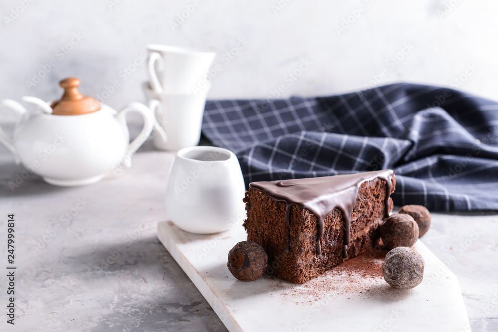 Piece of tasty chocolate cake on table
