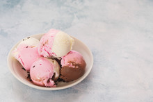 Neapolitan Ice Cream Scoops.  Chocolate, Strawberry And Vanilla Ice Cream In White Bowl With Vanilla Pods. Selective Focus, Copy Space