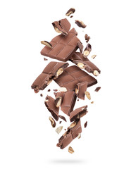 Wall Mural - Pieces of chocolate bar with nuts falling down on white background