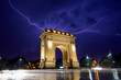 Lightning storm  in Bucharest city , Romania  with triumphal arch 