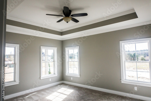 Modern New Construction Master Bedroom With Tray Ceiling And Fan