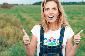 Amazed girl showing super sign with two hands